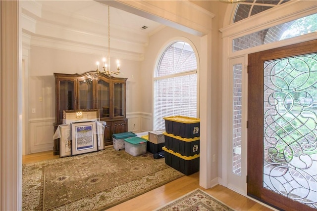 39 Grand Lake Cir, Savannah, GA 31405 - foyer with a chandelier, wood finished floors, a decorative wall, wainscoting, and ornamental molding