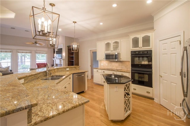 39 Grand Lake Cir, Savannah, GA 31405 - kitchen with black appliances, a large island, ornamental molding, backsplash, and light wood finished floors