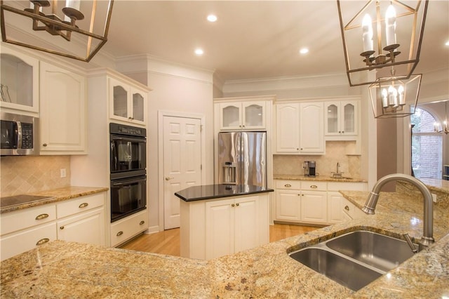 39 Grand Lake Cir, Savannah, GA 31405 - kitchen with a chandelier, black appliances, ornamental molding, light wood-type flooring, and light stone countertops