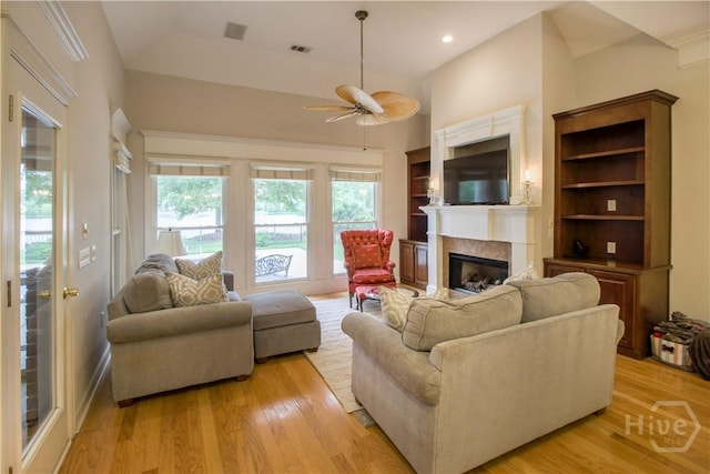 39 Grand Lake Cir, Savannah, GA 31405 - living room featuring ceiling fan, a fireplace, light wood-style flooring, built in features, and high vaulted ceiling