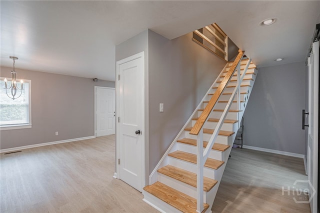177 E Burkhalter St, Pembroke, GA 31321 - stairway with wood finished floors, a chandelier, and recessed lighting