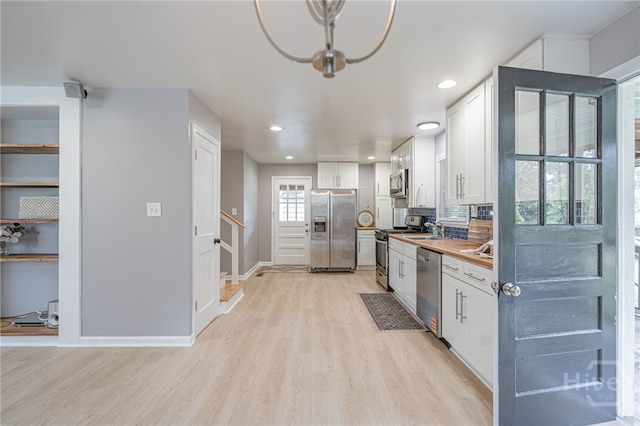 177 E Burkhalter St, Pembroke, GA 31321 - kitchen featuring stainless steel appliances, light wood-style flooring, white cabinetry, recessed lighting, and light countertops