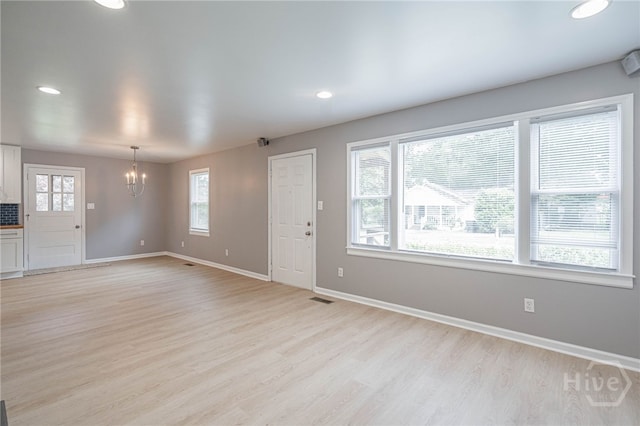 177 E Burkhalter St, Pembroke, GA 31321 - unfurnished living room featuring a chandelier, light wood finished floors, and recessed lighting
