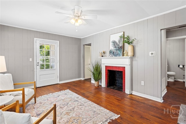 1915 Hawthorne St, Savannah, GA 31404 - living room with ornamental molding, a ceiling fan, a brick fireplace, and wood finished floors