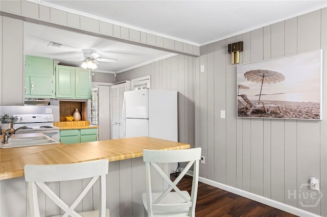 1915 Hawthorne St, Savannah, GA 31404 - kitchen with green cabinetry, exhaust hood, white appliances, dark wood-type flooring, and crown molding
