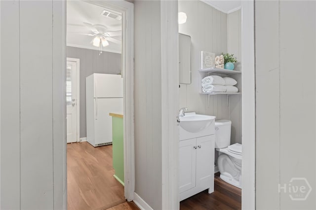 1915 Hawthorne St, Savannah, GA 31404 - half bathroom with crown molding, vanity, wood finished floors, a ceiling fan, and wooden walls