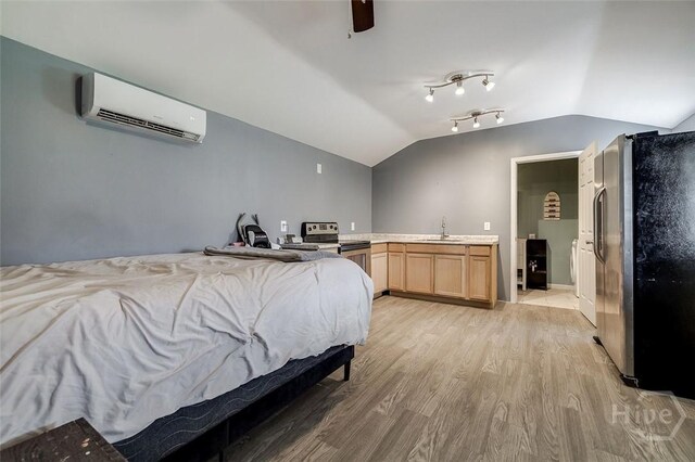 251 Old Louisville Rd, Guyton, GA 31312 - bedroom featuring a wall mounted AC, freestanding refrigerator, lofted ceiling, light wood finished floors, and a ceiling fan