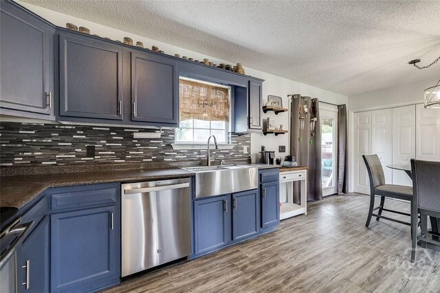 251 Old Louisville Rd, Guyton, GA 31312 - kitchen with appliances with stainless steel finishes, blue cabinets, a textured ceiling, tasteful backsplash, and dark countertops