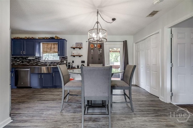 251 Old Louisville Rd, Guyton, GA 31312 - dining area with a chandelier, a textured ceiling, and dark wood-type flooring