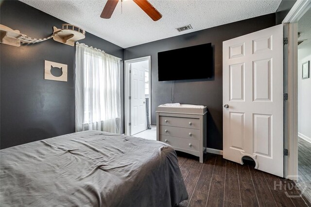 251 Old Louisville Rd, Guyton, GA 31312 - bedroom with a textured ceiling, dark wood-style flooring, and ceiling fan