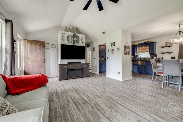 251 Old Louisville Rd, Guyton, GA 31312 - living room with ceiling fan, a chandelier, light wood-style floors, and lofted ceiling