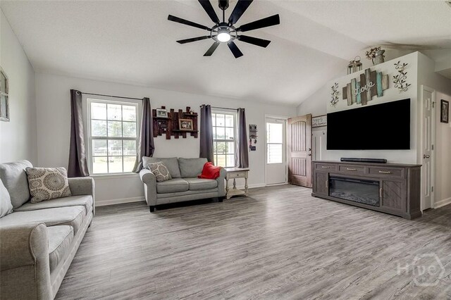 251 Old Louisville Rd, Guyton, GA 31312 - living area featuring a ceiling fan, lofted ceiling, light wood finished floors, and healthy amount of natural light