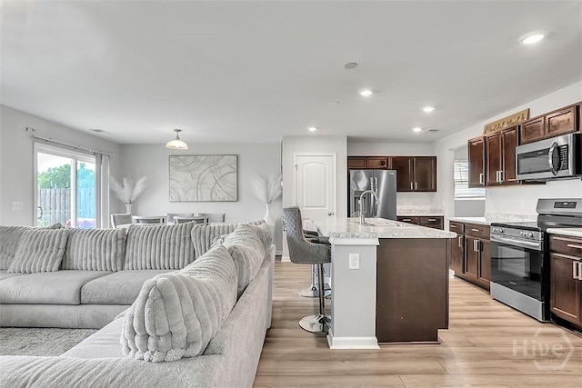 72 Marsh Salt Ln, Port Wentworth, GA 31407 - kitchen with appliances with stainless steel finishes, open floor plan, light wood-style flooring, dark brown cabinets, and recessed lighting