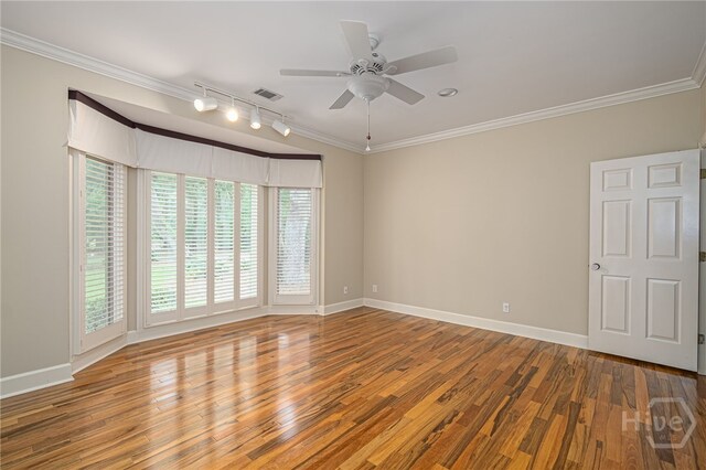 4 Hedgewood Ln, Savannah, GA 31411 - spare room with rail lighting, wood finished floors, healthy amount of natural light, a ceiling fan, and crown molding