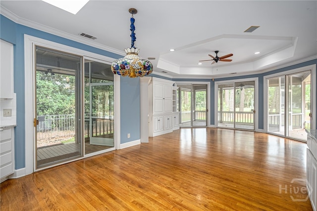 4 Hedgewood Ln, Savannah, GA 31411 - unfurnished room with a raised ceiling, light wood-type flooring, ornamental molding, and a ceiling fan