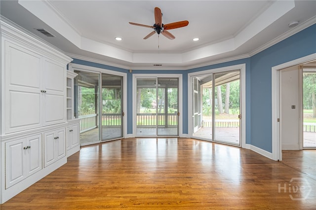 4 Hedgewood Ln, Savannah, GA 31411 - empty room with a raised ceiling, a smoke detector, plenty of natural light, wood finished floors, and crown molding