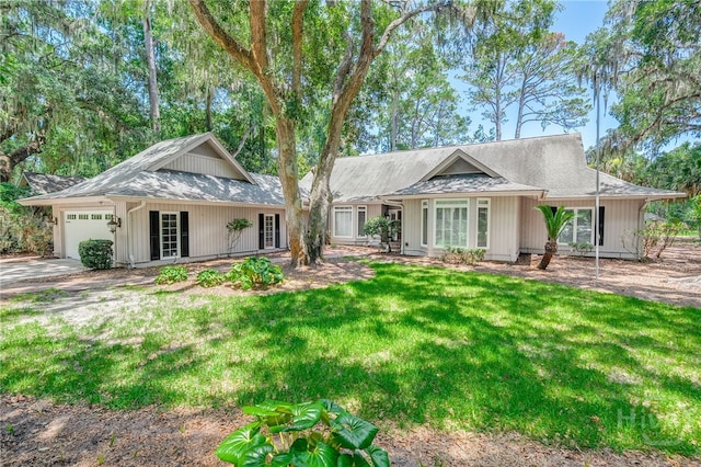 4 Hedgewood Ln, Savannah, GA 31411 - view of front of house featuring a garage, a front lawn, a shingled roof, and driveway