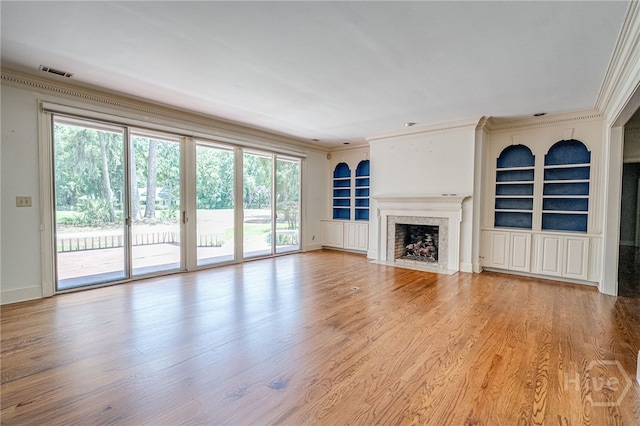 4 Hedgewood Ln, Savannah, GA 31411 - unfurnished living room with ornamental molding, built in features, healthy amount of natural light, and wood finished floors