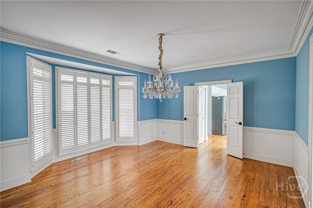 4 Hedgewood Ln, Savannah, GA 31411 - spare room with a chandelier, a wainscoted wall, wood finished floors, and crown molding