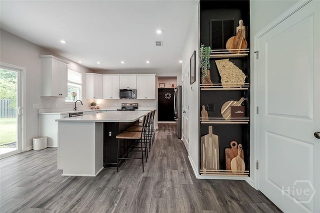 151 Excel Dr, Richmond Hill, GA 31324 - kitchen featuring stainless steel appliances, white cabinets, dark wood-style flooring, a kitchen island, and recessed lighting