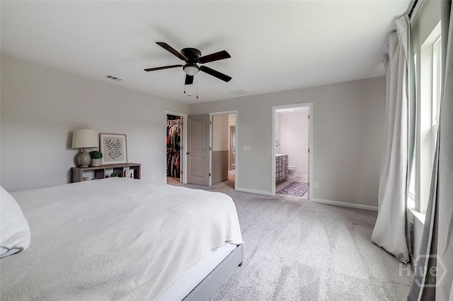 151 Excel Dr, Richmond Hill, GA 31324 - bedroom featuring a spacious closet, light carpet, a closet, ensuite bath, and ceiling fan