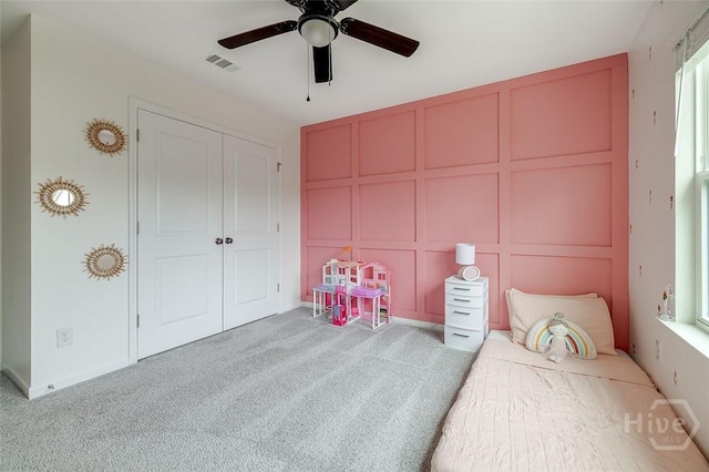 151 Excel Dr, Richmond Hill, GA 31324 - carpeted bedroom featuring a decorative wall, a closet, and a ceiling fan