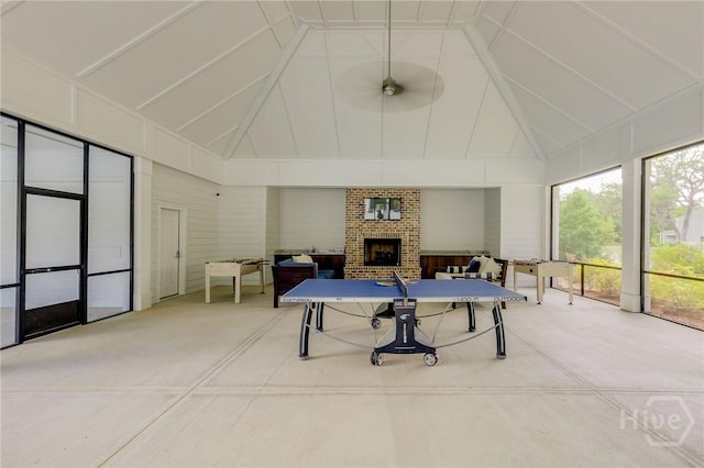 151 Excel Dr, Richmond Hill, GA 31324 - game room with high vaulted ceiling, carpet floors, a fireplace, and ceiling fan