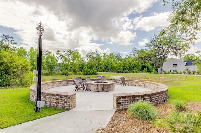 151 Excel Dr, Richmond Hill, GA 31324 - view of patio featuring a fire pit and view of wooded area