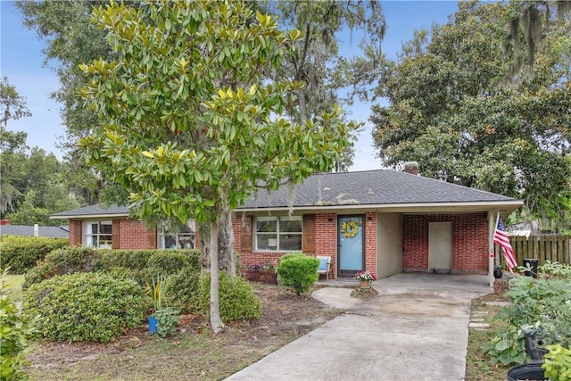2104 Mason Dr, Savannah, GA 31404 - view of front facade featuring driveway, brick siding, roof with shingles, and an attached carport