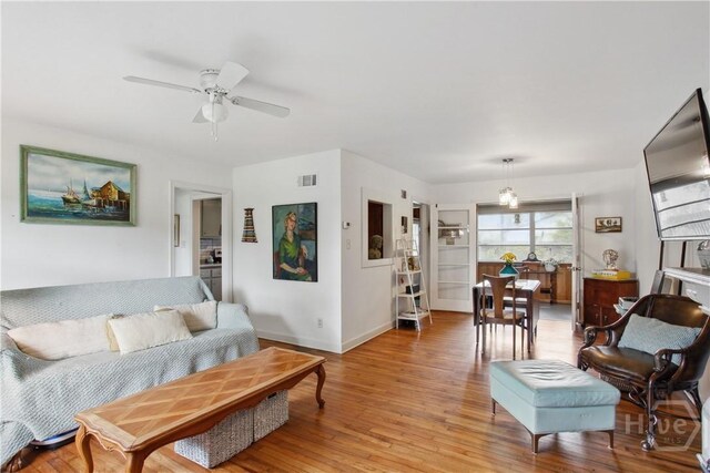 2104 Mason Dr, Savannah, GA 31404 - living area with ceiling fan, light wood-type flooring, and a chandelier
