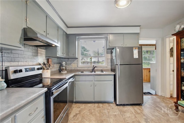 2104 Mason Dr, Savannah, GA 31404 - kitchen featuring stainless steel appliances, under cabinet range hood, gray cabinets, backsplash, and light countertops