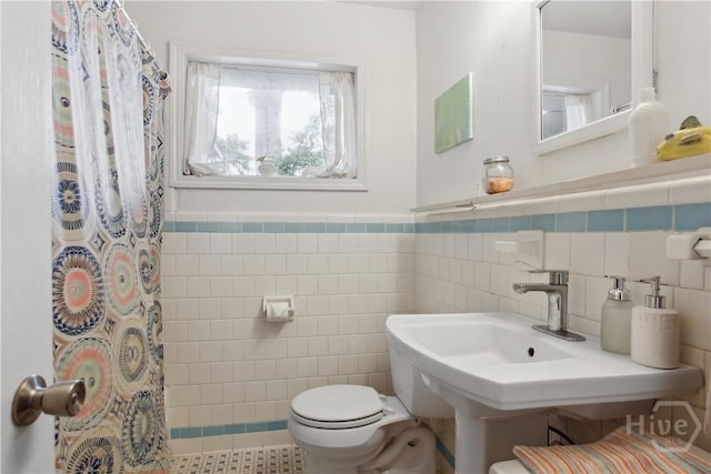 2104 Mason Dr, Savannah, GA 31404 - full bathroom featuring tile walls, a shower with curtain, and a wainscoted wall