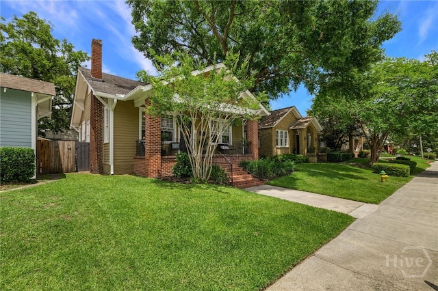316 E 51st St, Savannah, GA 31405 - bungalow with a porch, a chimney, and brick siding