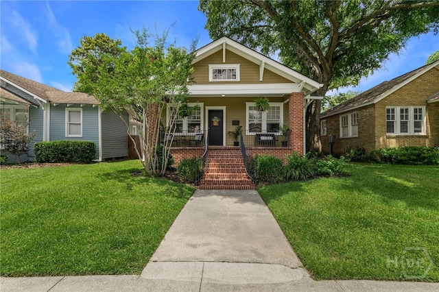 316 E 51st St, Savannah, GA 31405 - bungalow with a front lawn, a porch, and brick siding