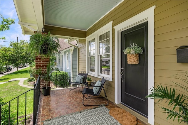 316 E 51st St, Savannah, GA 31405 - property entrance featuring a porch and a lawn
