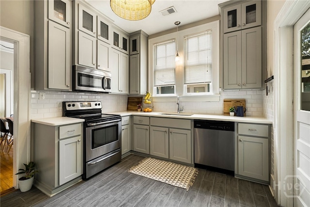 316 E 51st St, Savannah, GA 31405 - kitchen with stainless steel appliances, light countertops, dark wood finished floors, and gray cabinetry