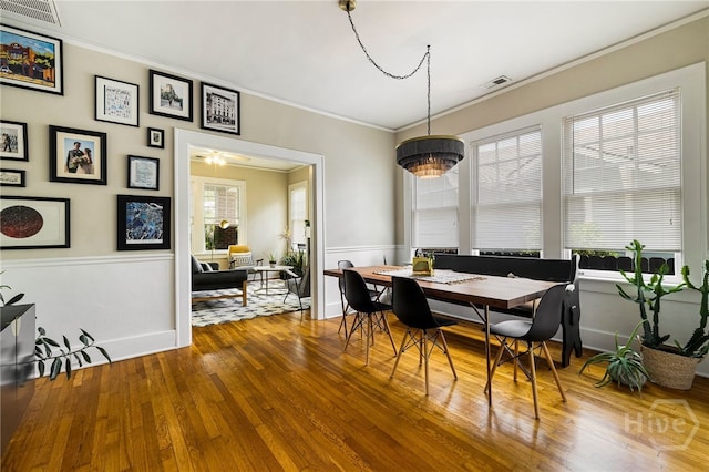 316 E 51st St, Savannah, GA 31405 - dining area with ornamental molding, hardwood / wood-style flooring, and a wainscoted wall