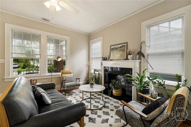 316 E 51st St, Savannah, GA 31405 - living area with ceiling fan, a fireplace, wood finished floors, and crown molding