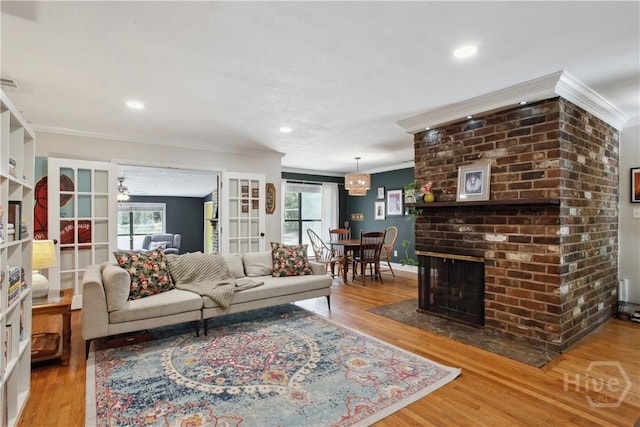 5527 Habersham St, Savannah, GA 31405 - living room featuring ornamental molding, wood finished floors, recessed lighting, and a fireplace