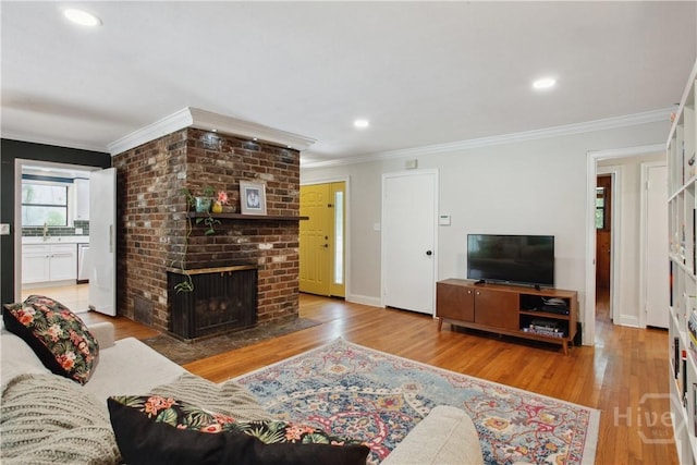 5527 Habersham St, Savannah, GA 31405 - living room featuring ornamental molding, wood finished floors, a fireplace, and recessed lighting