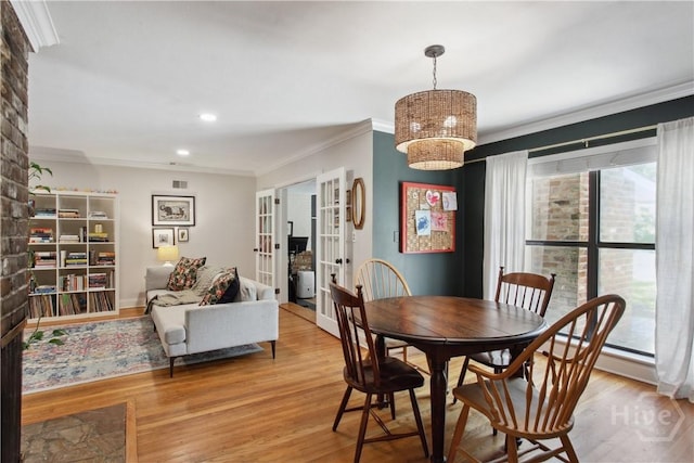 5527 Habersham St, Savannah, GA 31405 - dining area with crown molding, wood finished floors, french doors, recessed lighting, and a chandelier