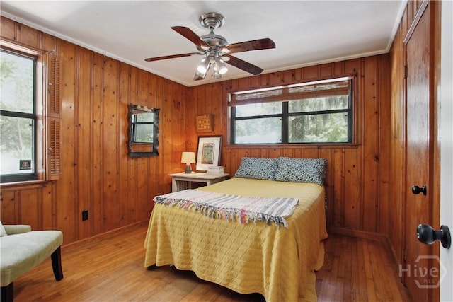 5527 Habersham St, Savannah, GA 31405 - bedroom with ornamental molding, wooden walls, and light wood-type flooring