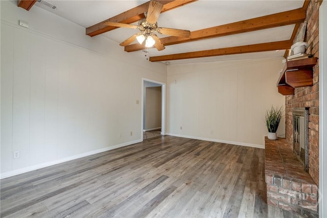 41 Barrington Cir, Savannah, GA 31419 - unfurnished living room featuring wood finished floors, beamed ceiling, a brick fireplace, and a ceiling fan