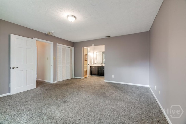 41 Barrington Cir, Savannah, GA 31419 - unfurnished bedroom featuring carpet floors, connected bathroom, and a textured ceiling