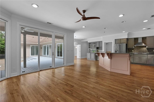8 Boars Nest Ln, Savannah, GA 31411 - kitchen with stainless steel fridge with ice dispenser, wall chimney exhaust hood, ceiling fan, ornamental molding, and gray cabinetry