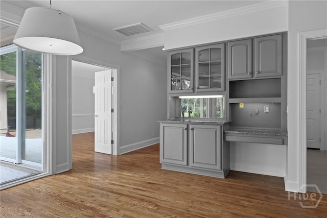 8 Boars Nest Ln, Savannah, GA 31411 - bar area featuring ornamental molding, plenty of natural light, wood finished floors, and pendant lighting