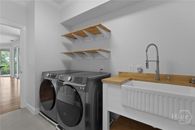 8 Boars Nest Ln, Savannah, GA 31411 - laundry area with washer and dryer, ornamental molding, and light wood-type flooring