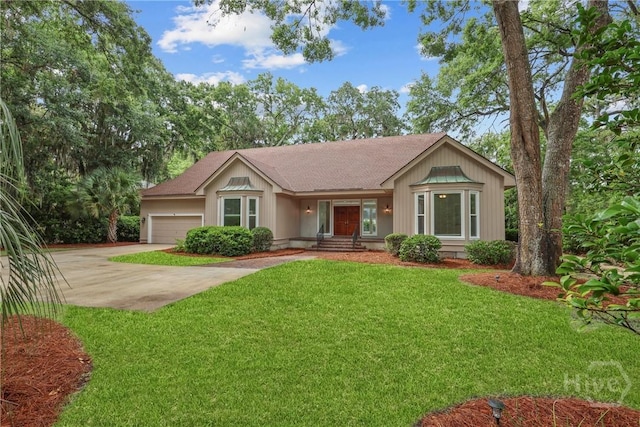 8 Boars Nest Ln, Savannah, GA 31411 - ranch-style house featuring concrete driveway, an attached garage, a front lawn, and roof with shingles