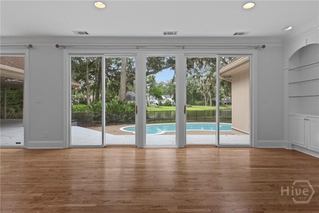 8 Boars Nest Ln, Savannah, GA 31411 - doorway with wood finished floors, recessed lighting, and crown molding