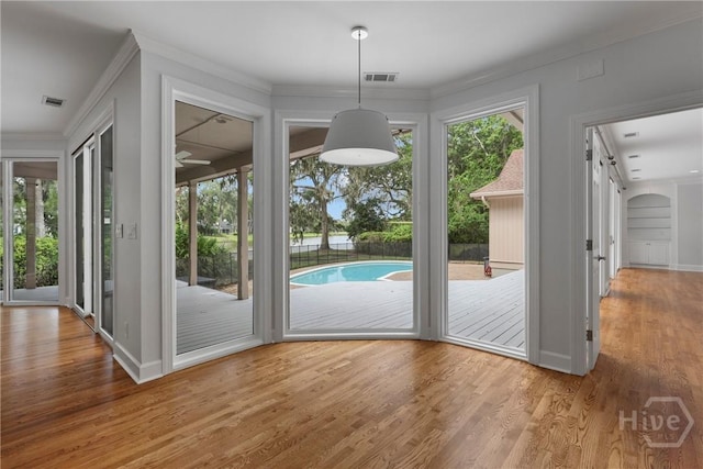 8 Boars Nest Ln, Savannah, GA 31411 - unfurnished dining area with wood finished floors, crown molding, and a barn door
